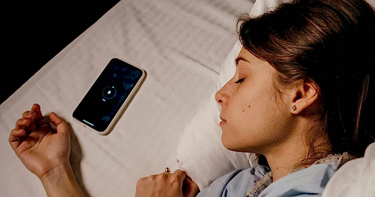 Digital Detox: Woman Sleeping Next to a Phone